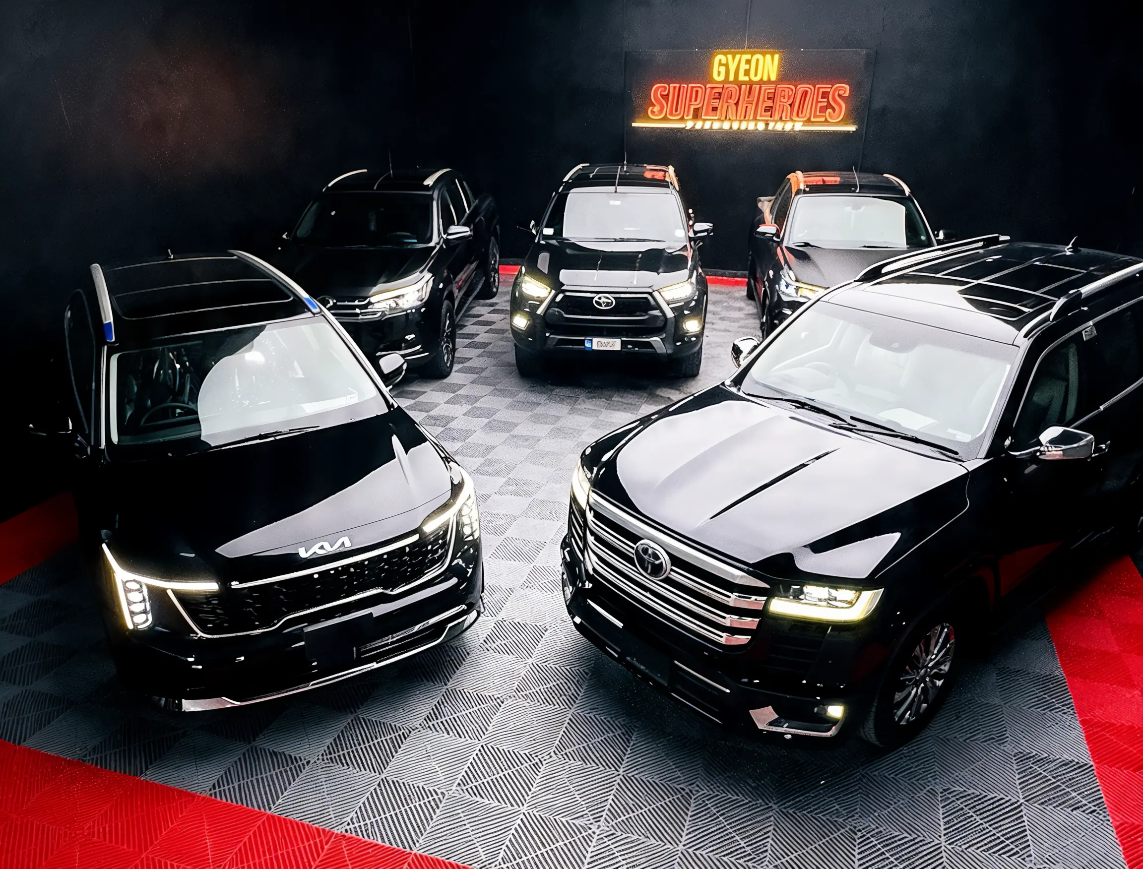 Inside the Auto Extreme studio — a fleet of coated vehicles under the GYEON Superheroes sign